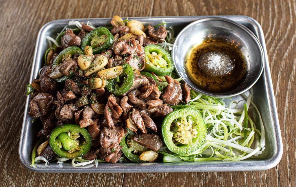 Stir-fried Chicken Gizzard · Chicken gizzard stir-fried with jalapeño and garlic with a side of scallions and salt & pepper with sesame oil dip.