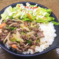 Bulgogi Over Rice · Steamed white rice topped with Korean-style marinated beef rib-eye with assorted vegetables.