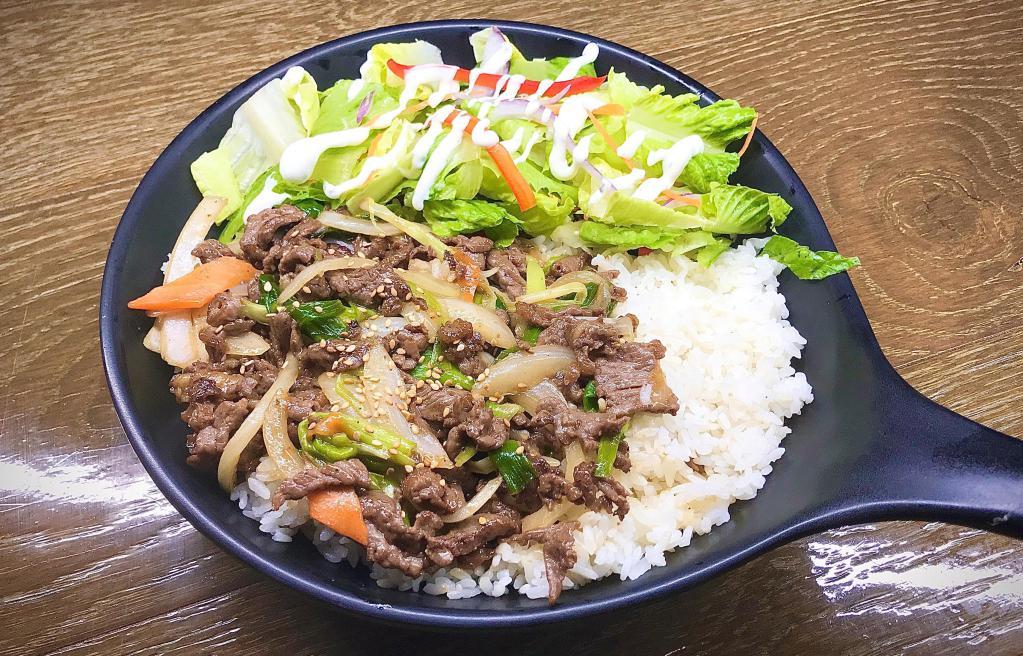 Bulgogi Over Rice · Steamed white rice topped with Korean-style marinated beef rib-eye with assorted vegetables.