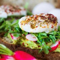 Avocado Toast Eggs · Avocado, poached eggs, arugula, sunflower seeds with balthazar multigrain bread and lyonnais...