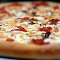 Classic Margherita Pizza · Extra cheese, Roma tomatoes, garlic, olive oil and basil.