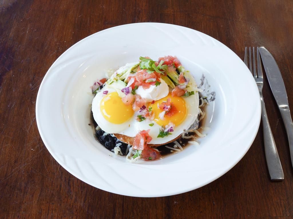 Breakfast Huevos Rancheros · 2 eggs any style, choice of flour or crispy corn tortillas layered with seasoned black beans, ranchero sauce and fresh pico topped with avocado and sour cream.