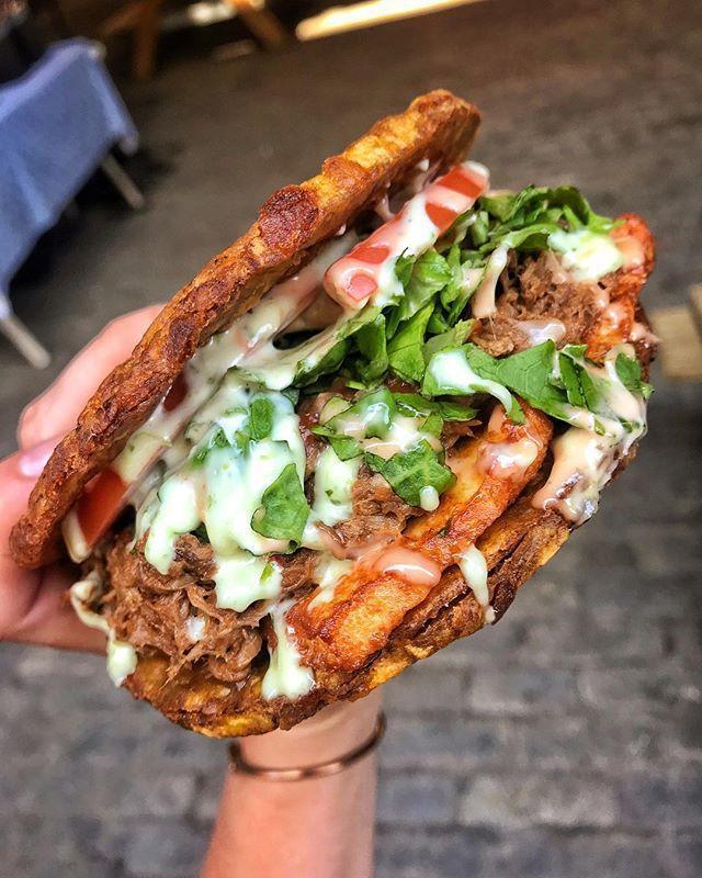 Shredded Beef Patacon · Twice Fried Green Plantain sandwich with Shredded Beef topped with lettuce, tomato, fried cheese, our signature house mayo, and ketchup