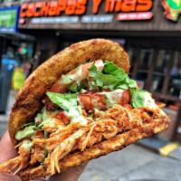Shredded Chicken Patacon · Twice Fried Green Plantain sandwich with Shredded Chicken topped with lettuce, tomato, fried...
