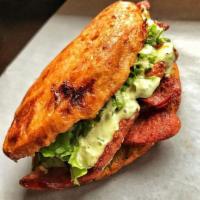 Chorizo Yoyo · Sweet plantain sandwich with Chorizo topped with lettuce, tomato, fried cheese, our signatur...