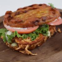 Roast Pork Yoyo · Sweet plantain sandwich with slow cooked Roast Pork topped with lettuce, tomato, fried chees...