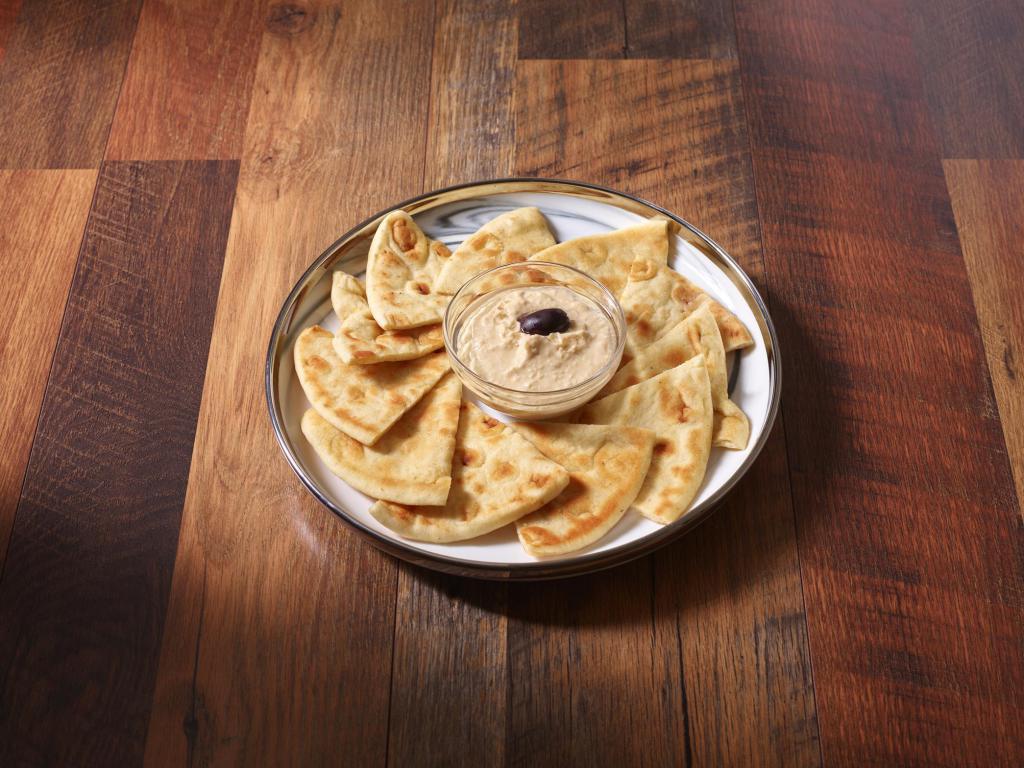 Hummus · Served with pita. Choose from: traditional, roasted red pepper, roasted garlic, jalapeno cilantro, smoked chipotle and sun-dried tomatoes.