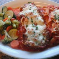 Eggplant Parmigiana · Breaded eggplant covered in marinara sauce and topped off with cheese. Served with vegetable...