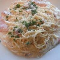 Spaghetti a la Carbonara · Creamy white sauce topped with bacon and ham. Served with bread and butter.