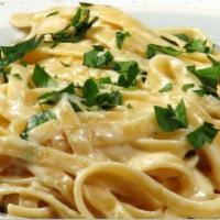 Fettuccine Alfredo · Fettuccine, cream sauce with plenty of Parmesan cheese. Served with bread and butter.