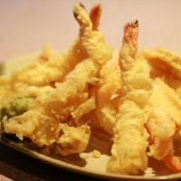 E9. Mix Tempura · 5 pieces of fried pawns and vegetables served with dipping sauce. Served with miso soup, hou...