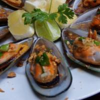 18. Six Pieces Green Mussels · Broiled green mussels in 1/2 shell. Topped with fried onion, oiled green onion and peanut. S...