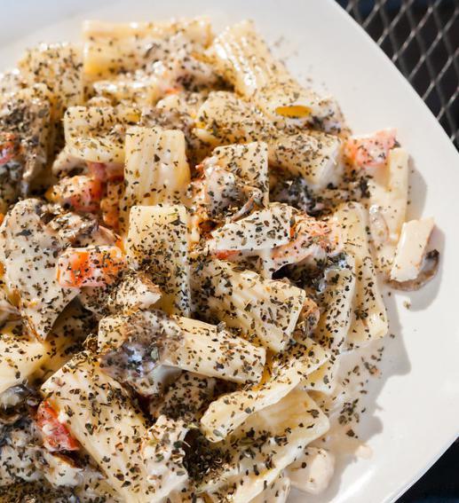 Rigatoni Alfredo · Penne pasta with Alfredo sauce, mushrooms, tomatoes, garlic, basil. Served with garlic bread. Add protein for an additional charge.