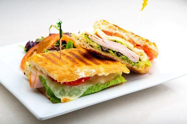 Turkey Panini · Lettuce, tomato, sprouts and olives. Includes our house made pesto (nut free), sun-dried tomato, mustard and mayo. Served with a side salad.