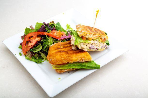 Tuna Panini · Tomato, red onions, black olives and lettuce. Includes our house made pesto (nut free), sun-dried tomato, mustard and mayo. Served with a side salad.