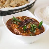 M20. Goat Curry · Goat cooked in thick curry sauce and garnished with cilantro. Served with 8 Oz Rice.