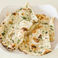 Garlic Naan · Plain naan cooked in tandoor topped with garlic. Vegetarian.