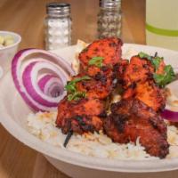 Spicy Chicken Kabobs · Chicken marinated in spices and our house-special red hot yougrut sauce & grilled. Served wi...