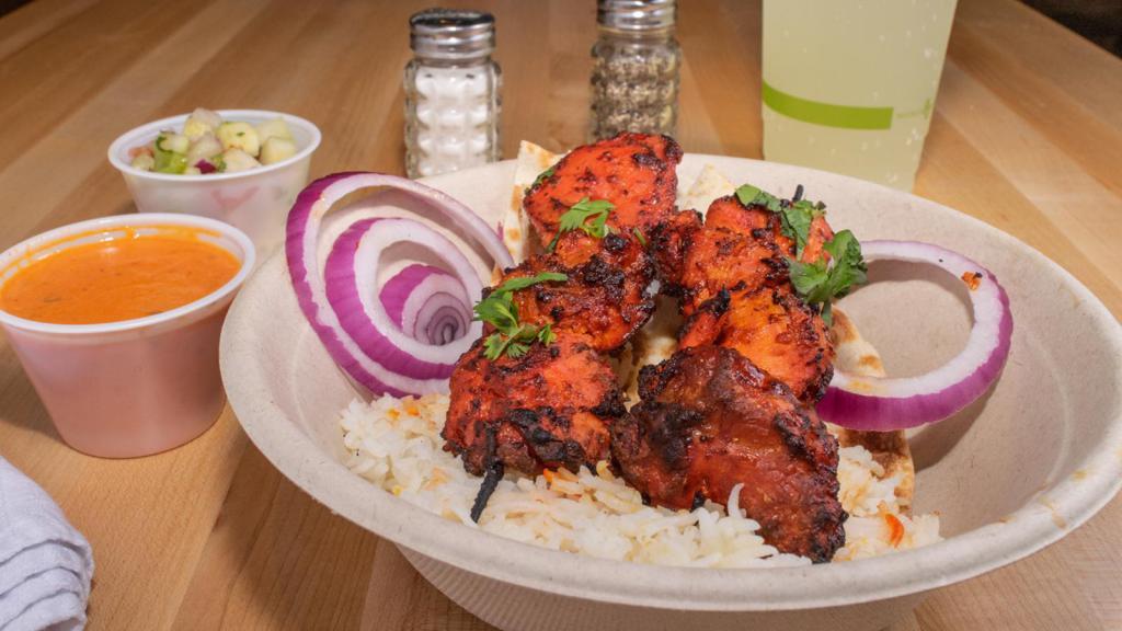 Spicy Chicken Kabobs · Chicken marinated in spices and our house-special red hot yougrut sauce & grilled. Served with basmati rice, kachumbar salad, naan, & tikka masala sauce.