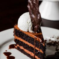 Triple Layer Chocolate Cake · Served with hot fudge and whipped cream.