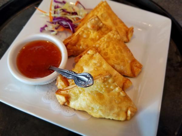 6. Crab Rangoon · Golden fried wonton skin stuffed with imitation crab and cream cheese. Served with sweet chili sauce.