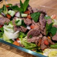 18. Beef Salad · Thin sliced and grilled beef with lettuce, tomatoes, cucumbers, mint leaves, cilantro and on...