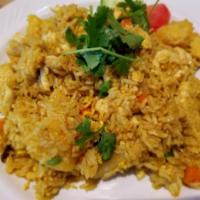 52. Pineapple Fried Rice · Fried rice with egg, pineapple, carrots, peas, cashew nut, raisins and onions.