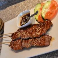 SP15. Beef Skewer with Sticky Rice · Marinated beef and grilled on skewers. Served with sticky rice.