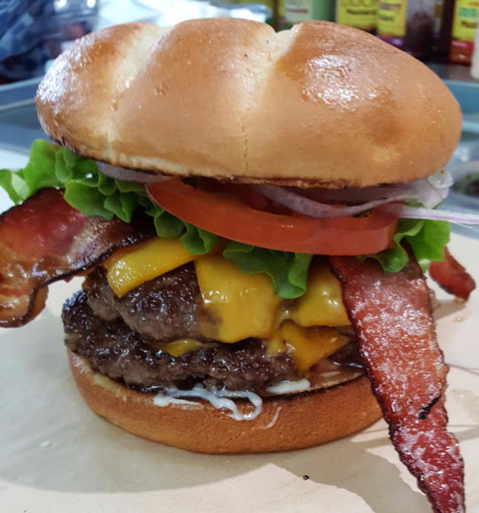 Double Bacon Cheeseburger · Two 100% beef patties on a toasted Brioche bun topped with Applewood smoked bacon, Cheddar cheese, lettuce, tomato, red onion, pickle, mayo, mustard, and ketchup.