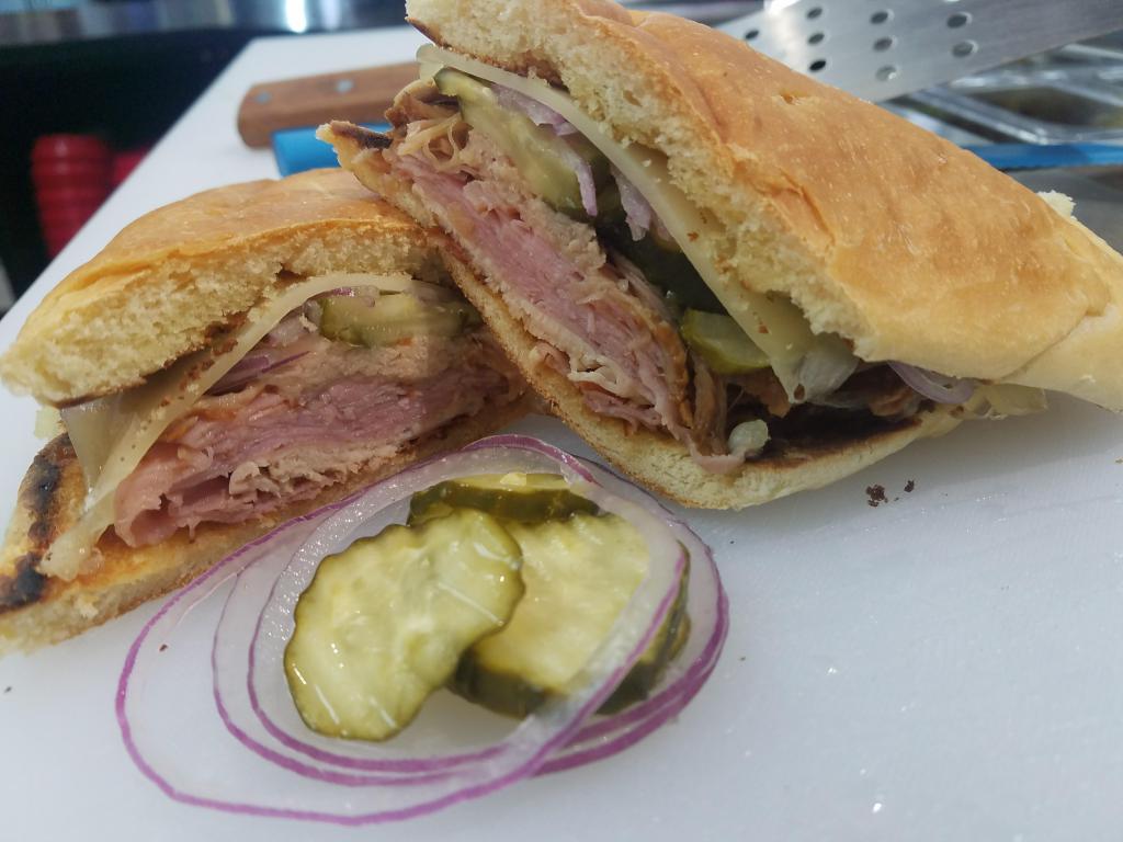 Cuban Sub · Ham, carnitas, turkey, Swiss cheese, pickles, and mustard on a pressed hoagie.