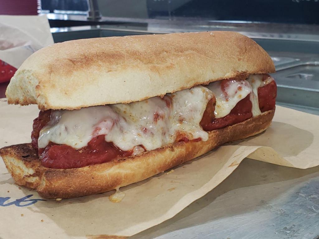 Meatball Sub · Sauteed meatballs marinated in a zesty marinara sauce, topped with Parmesan and Provolone cheese on a toasty Italian hoagie.