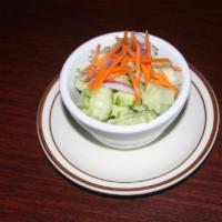 Cucumber Salad · Fresh cucumber, red onions and carrots in a mild sweet and sour dressing.