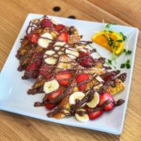 Nutella French Toast · Our classic favorite French toast with fresh strawberries, bananas and nutella drizzled on t...