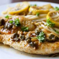Chicken Piccata · Chicken dipped in egg sauteed with capers in white wine and lemon sauce. Served with pasta a...
