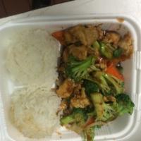 Chicken Broccoli · Chicken, broccoli and carrot strips stir fried in a brown sauce. Served with steamed or frie...