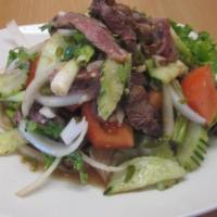 2. Grilled Pork Salad · Grilled marinated pork tossed with onion, tomato, cucumber, cilantro and chili in a lime dre...