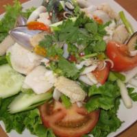 4. Combination Seafood Salad · Shrimp, crab, squid, scallop, fish, chili and tomato in a lime dressing. No MSG.