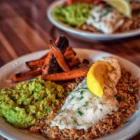 Broiled Haddock Plate · Served over rice pilaf with mushy peas and roasted carrots.