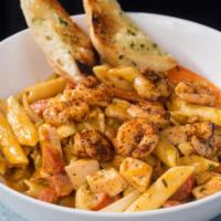 Cajun Pasta · Shrimp, chicken, smoked andouille sausage, onions, peppers, and penne pasta tossed in our ho...