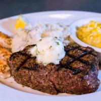 Surf and Turf · Aged 8 oz filet, signature Rockfish spice, garlic butter, loaded red potatoes, and sauteed c...