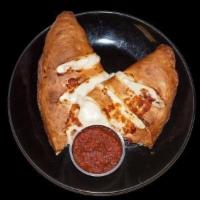 Traditional Calzone · Tomato sauce, mozzarella cheese, ham, pepperoni, salami, mushrooms, bell peppers, red onions...