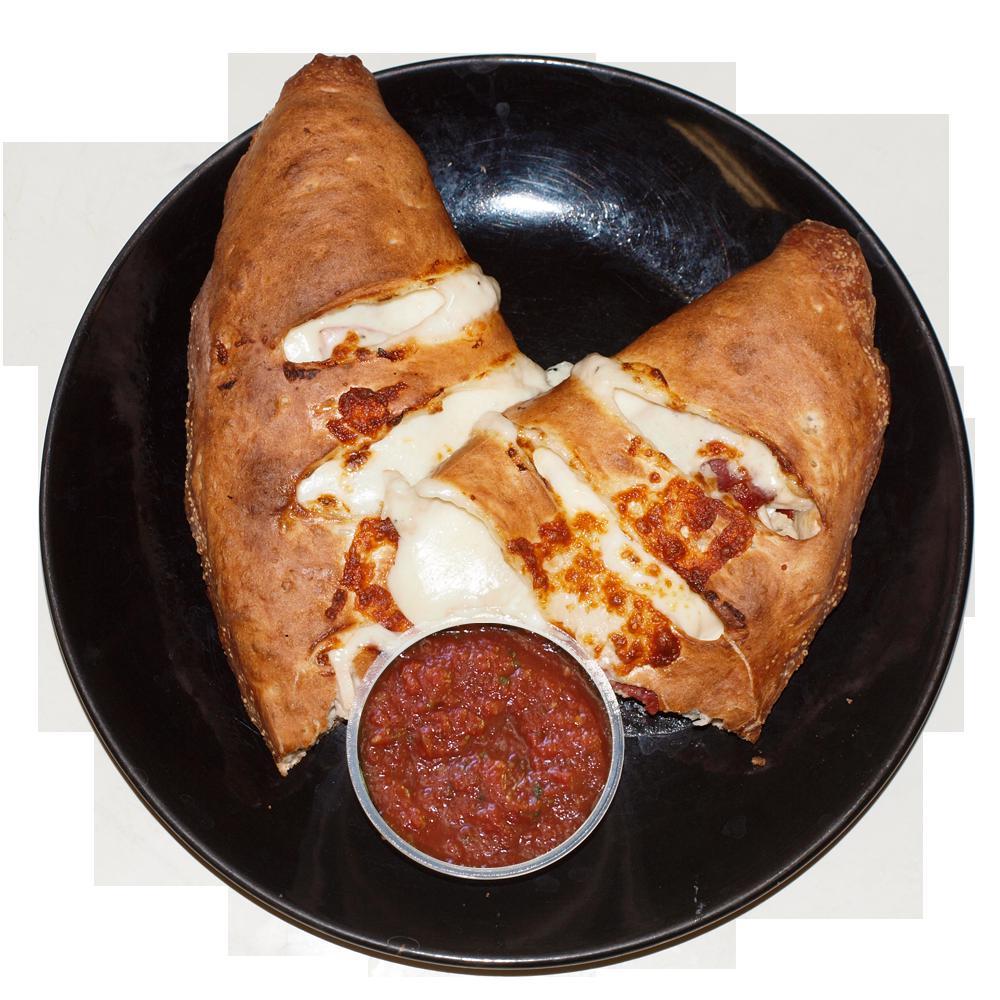 Hawaiian Calzone · Tomato sauce, mozzarella cheese, ham, pineapple (served with A side of red sauce).