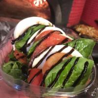Insalata Caprese · House mozzarella, vine ripened tomatoes, fresh basil and salt drizzled with balsamic and ext...