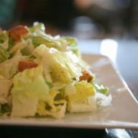 Caesar Salad · Crisp romaine lettuce tossed with our house made dressing and croutons then topped with Parm...