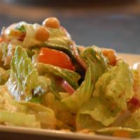 Crush Italian Salad · Crisp romaine lettuce with tomato, cucumbers, chickpeas, green peppers and red onion. Tossed...