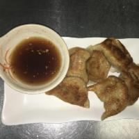 B7. Pan-Fried Pork Dumplings 锅贴（8） · Your classic pot stickers. Contains a pork and scallion filling. Each order comes with eight.