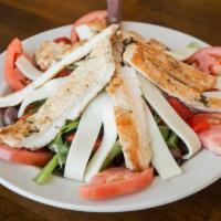 Tuscany Salad · Marinated grilled chicken served over mixed greens, mozzarella cheese, roasted peppers, toma...