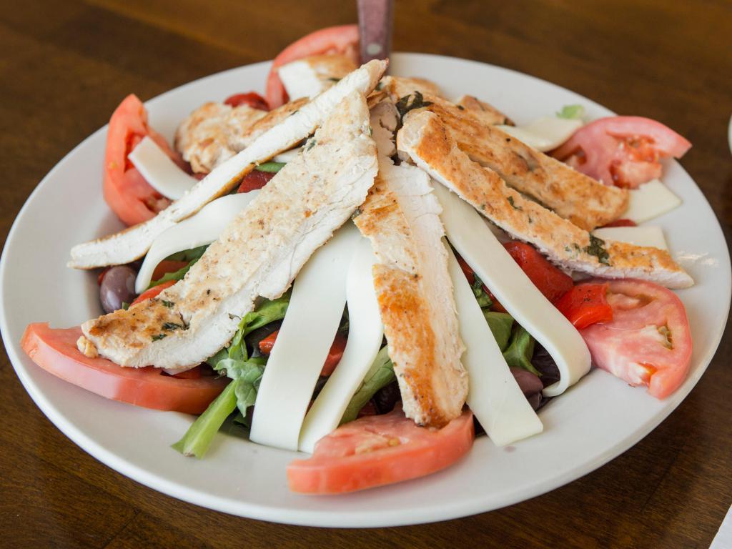 Tuscany Salad · Marinated grilled chicken served over mixed greens, mozzarella cheese, roasted peppers, tomatoes, imported olives and balsamic vinaigrette dressing.