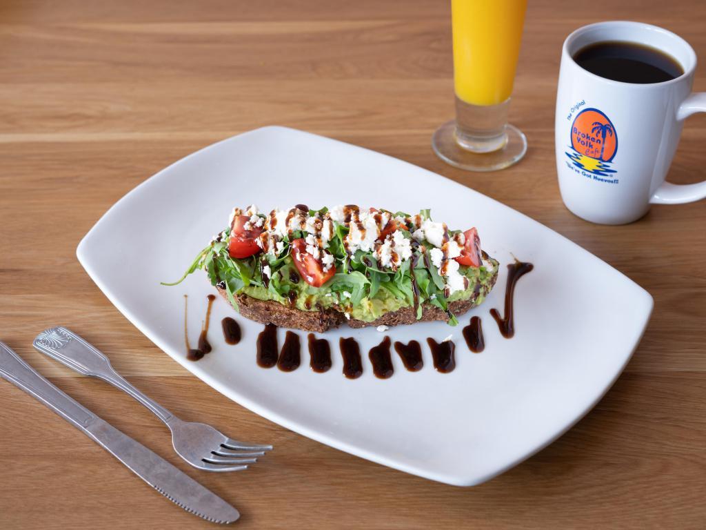Feta Avocado Toast · Thick sliced artisan grain bread lightly toasted and topped with fresh avocado, arugula, cherry tomatoes, feta cheese and a balsamic drizzle. Add 2 poached egg for an additional charge.