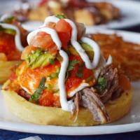 Sope Benedict · 2 extra thick and crispy corn tortillas filled with shredded beef and topped with poached eg...